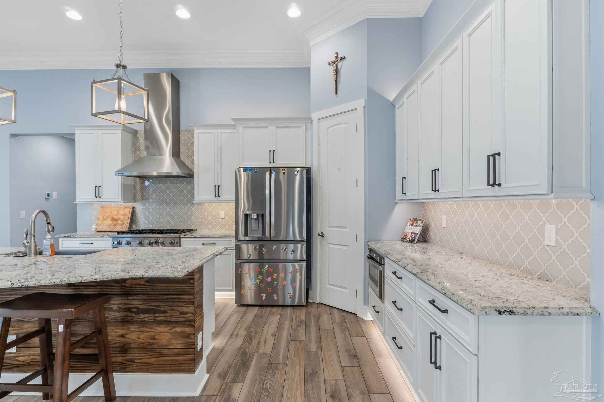 2018 Rambling Oaks Drive Cantonment, FL 32533 - Photo 25 of 64 a kitchen with granite countertop a sink stainless steel appliances and cabinets