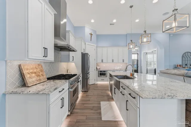 a bathroom with a granite countertop sink a large mirror and a shower