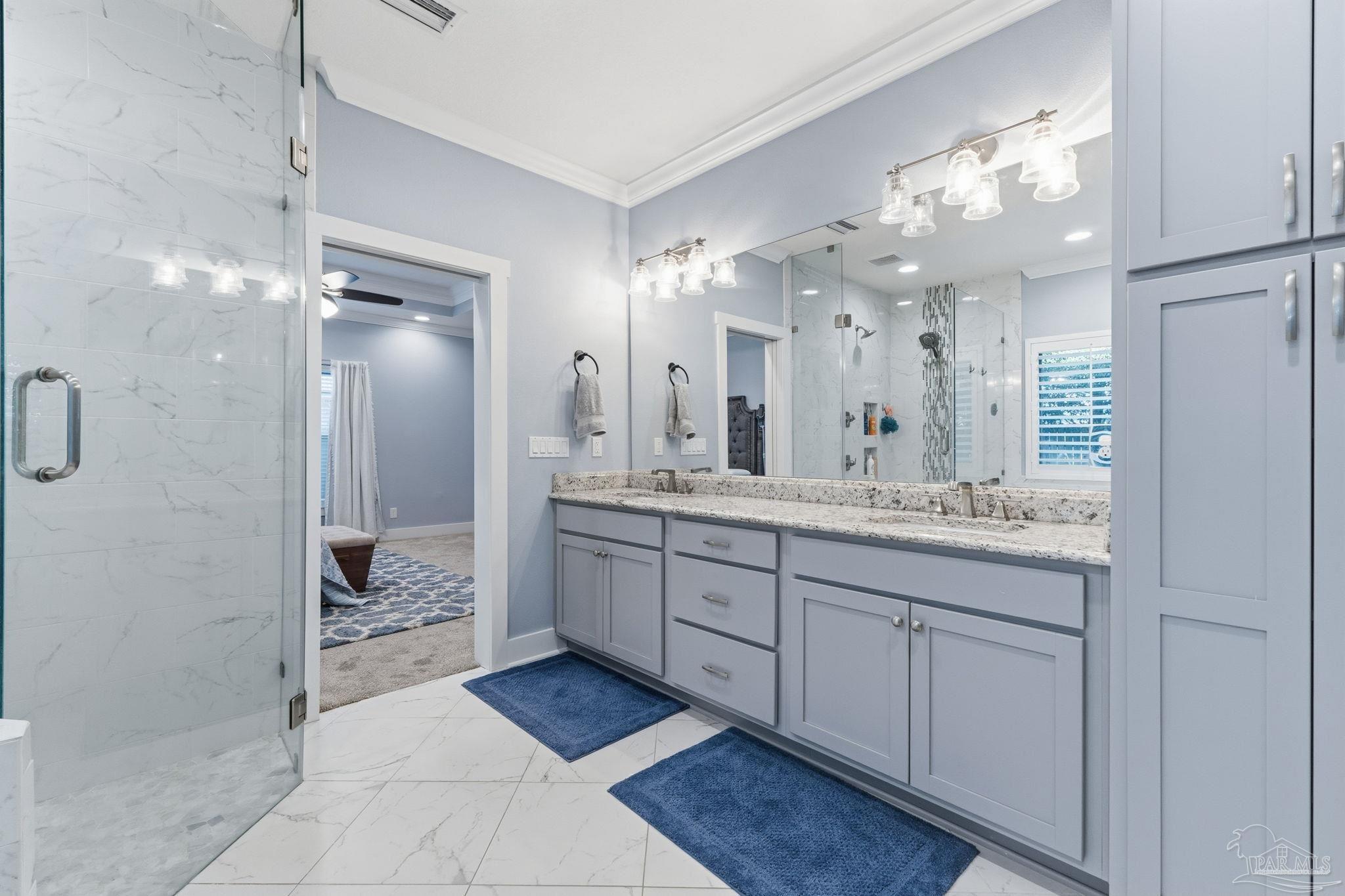 2018 Rambling Oaks Drive Cantonment, FL 32533 - Photo 34 of 64 a bathroom with a granite countertop sink mirror and a shower