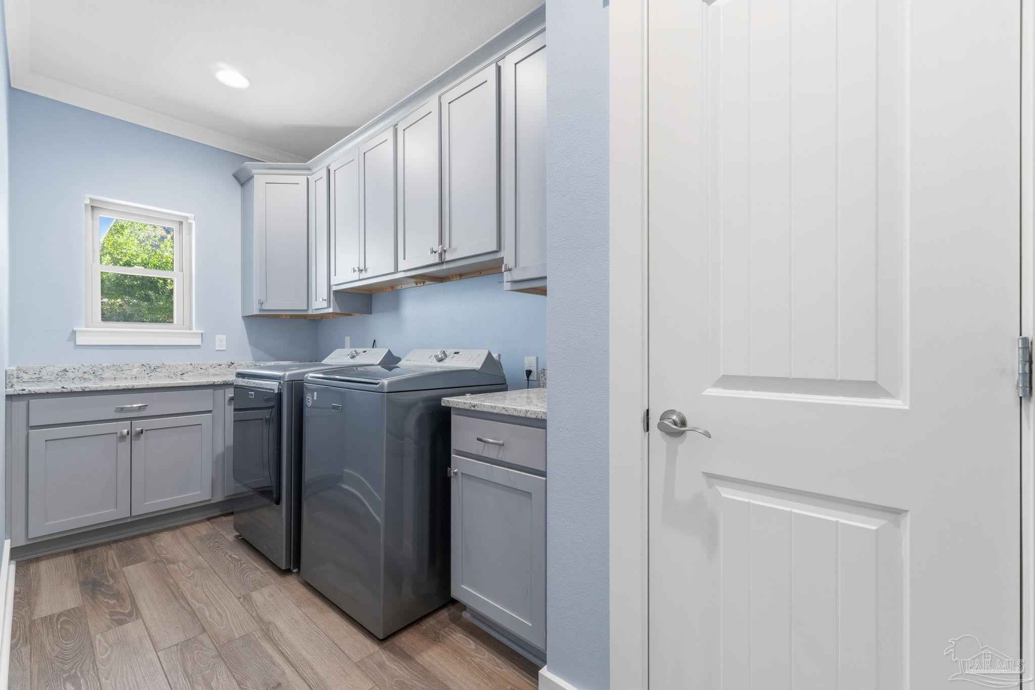 2018 Rambling Oaks Drive Cantonment, FL 32533 - Photo 39 of 64 a utility room with cabinets washer and dryer