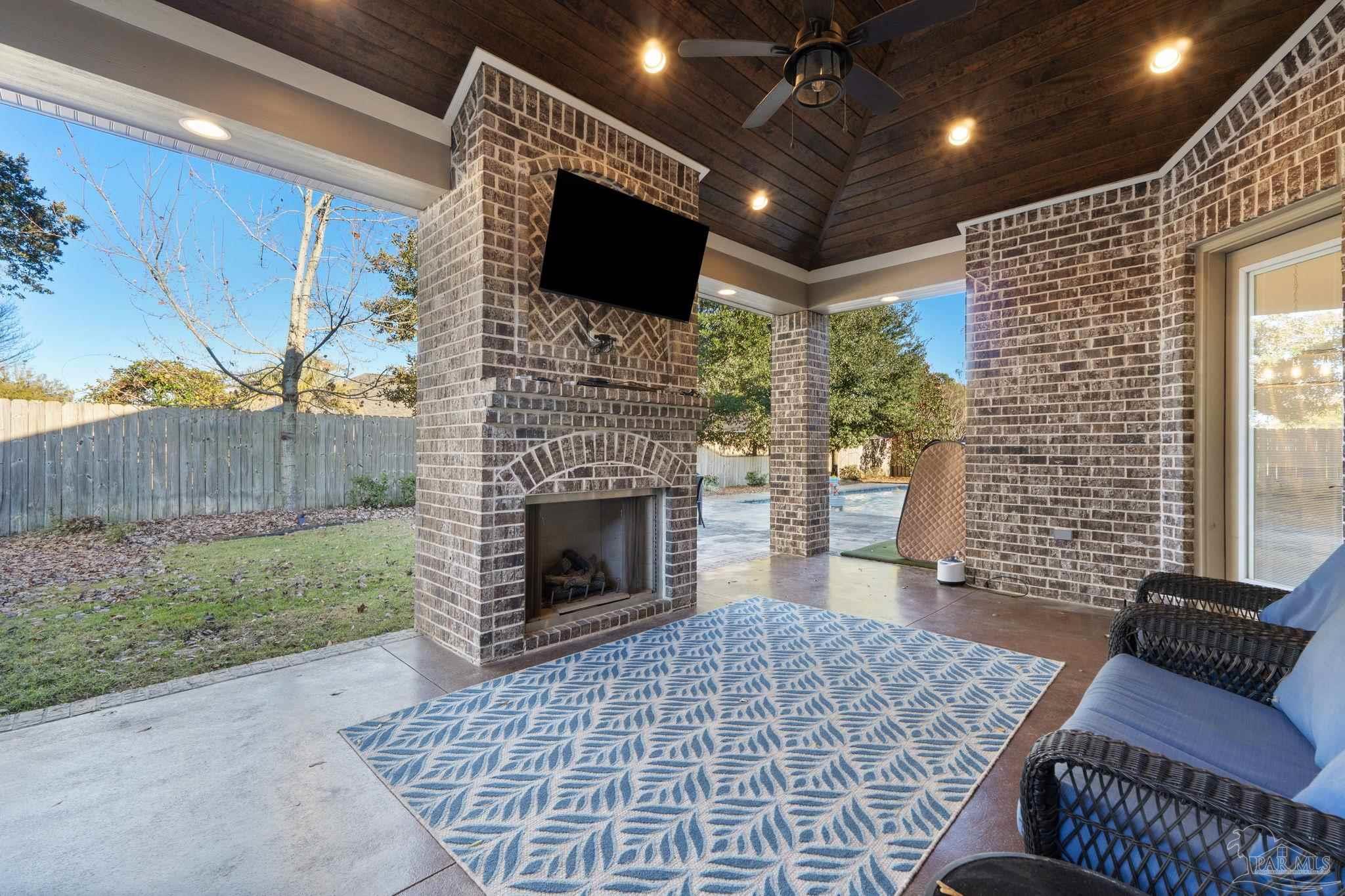 2018 Rambling Oaks Drive Cantonment, FL 32533 - Photo 47 of 64 a living room with furniture a flat screen tv and a fireplace