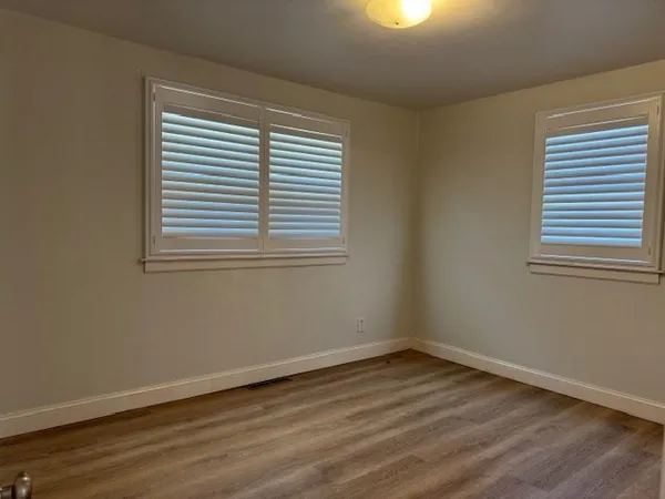 wooden floor and window in an empty room