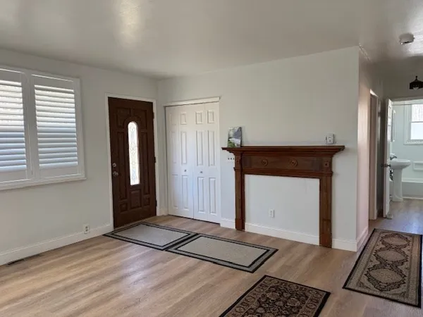 a view of a livingroom with wooden floor and a window