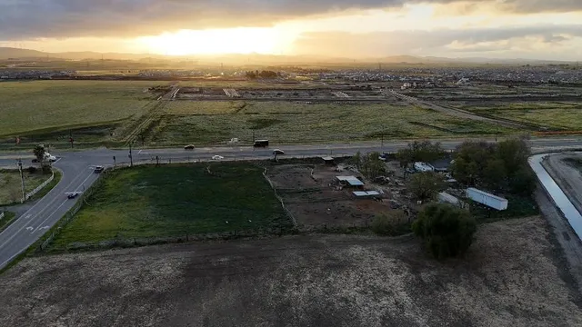 an aerial view of a houses with a lake
