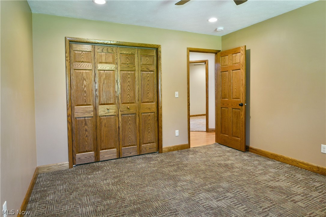 754 Warner Road Hubbard, OH 44425 - Photo 38 of 46 Spacious room featuring textured carpeting, beige wall tones, and wood-finish trim