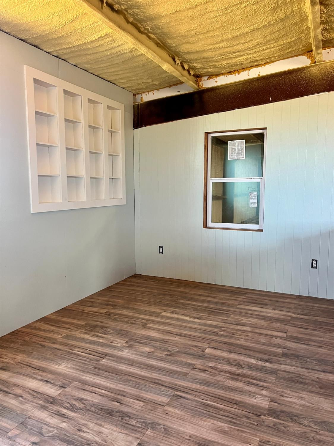1114 County Road 260 Plains, TX 79355 - Photo 13 of 20 a view of an empty room with wooden floor and a window