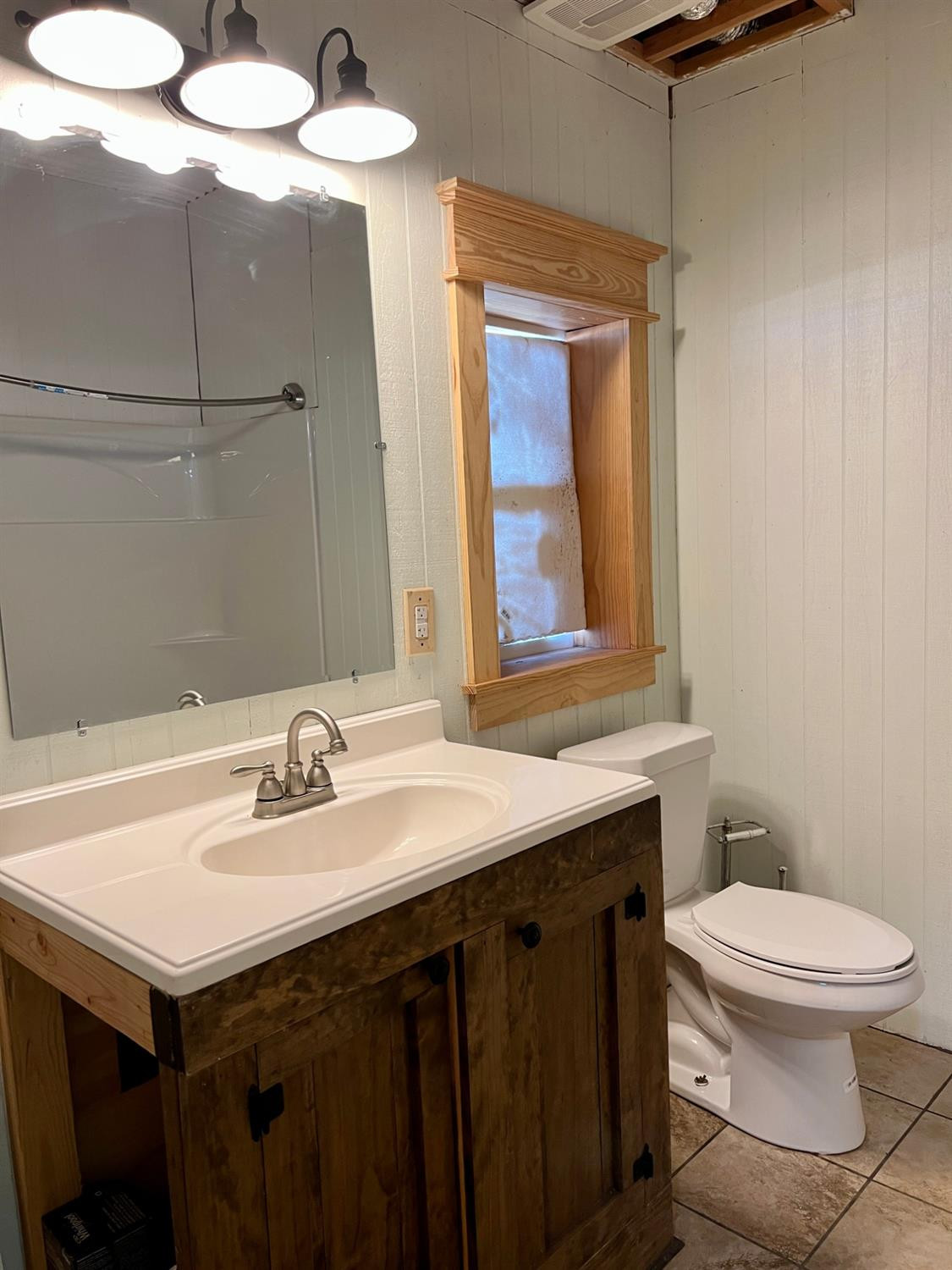 1114 County Road 260 Plains, TX 79355 - Photo 18 of 20 a bathroom with a sink a toilet and mirror