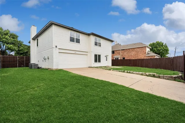 a view of white house with a yard