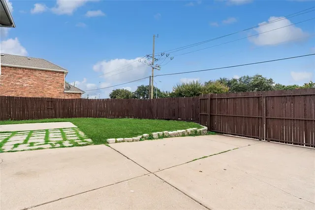 a view of garden with wooden fence