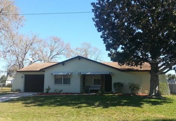 4684 Elwood Road Spring Hill, FL 34608 - Photo 1 of 1 a house that has tree in front of it