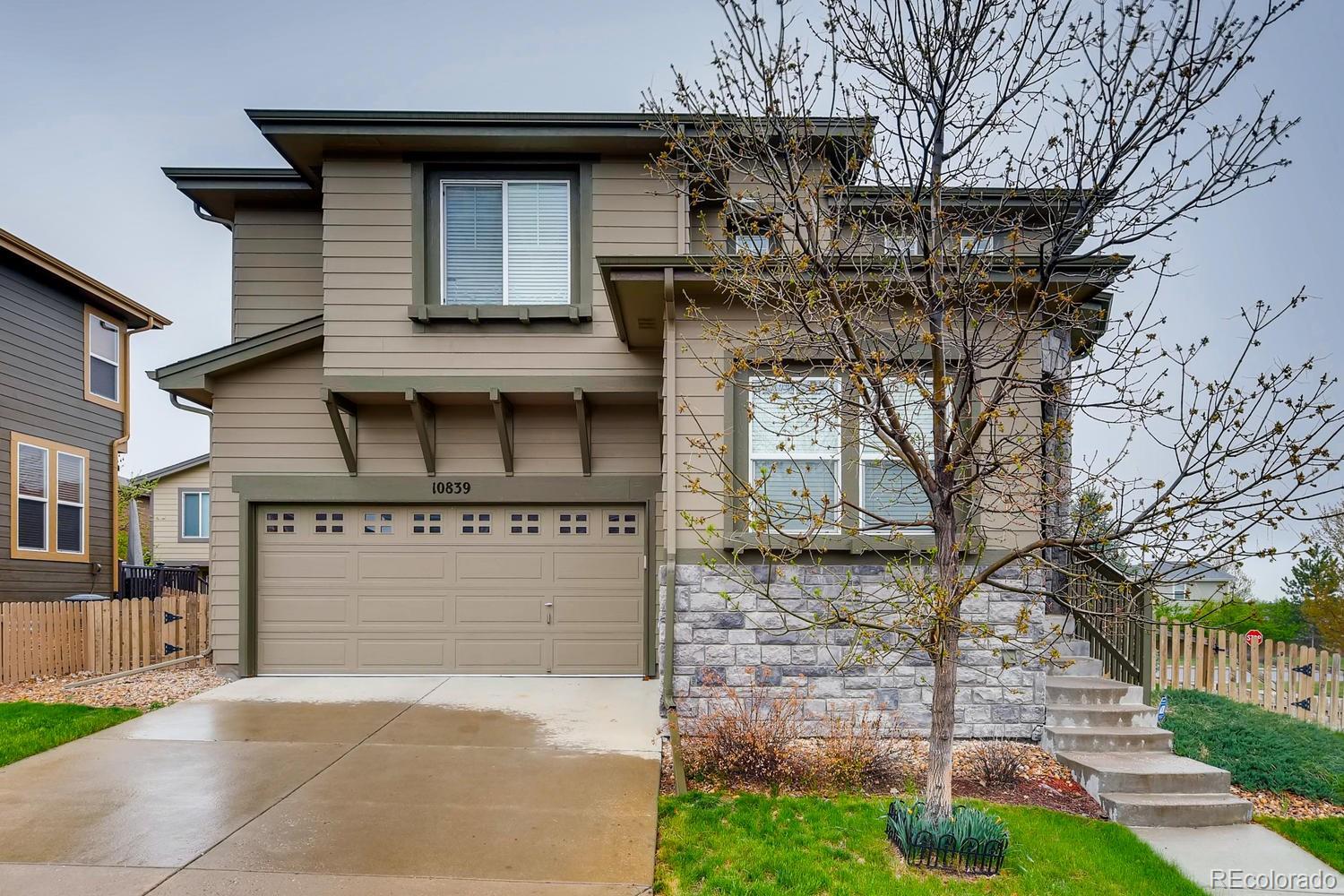 10839 Brooklawn Road Highlands Ranch, CO 80130 - Photo 1 of 32 a front view of a house with garden