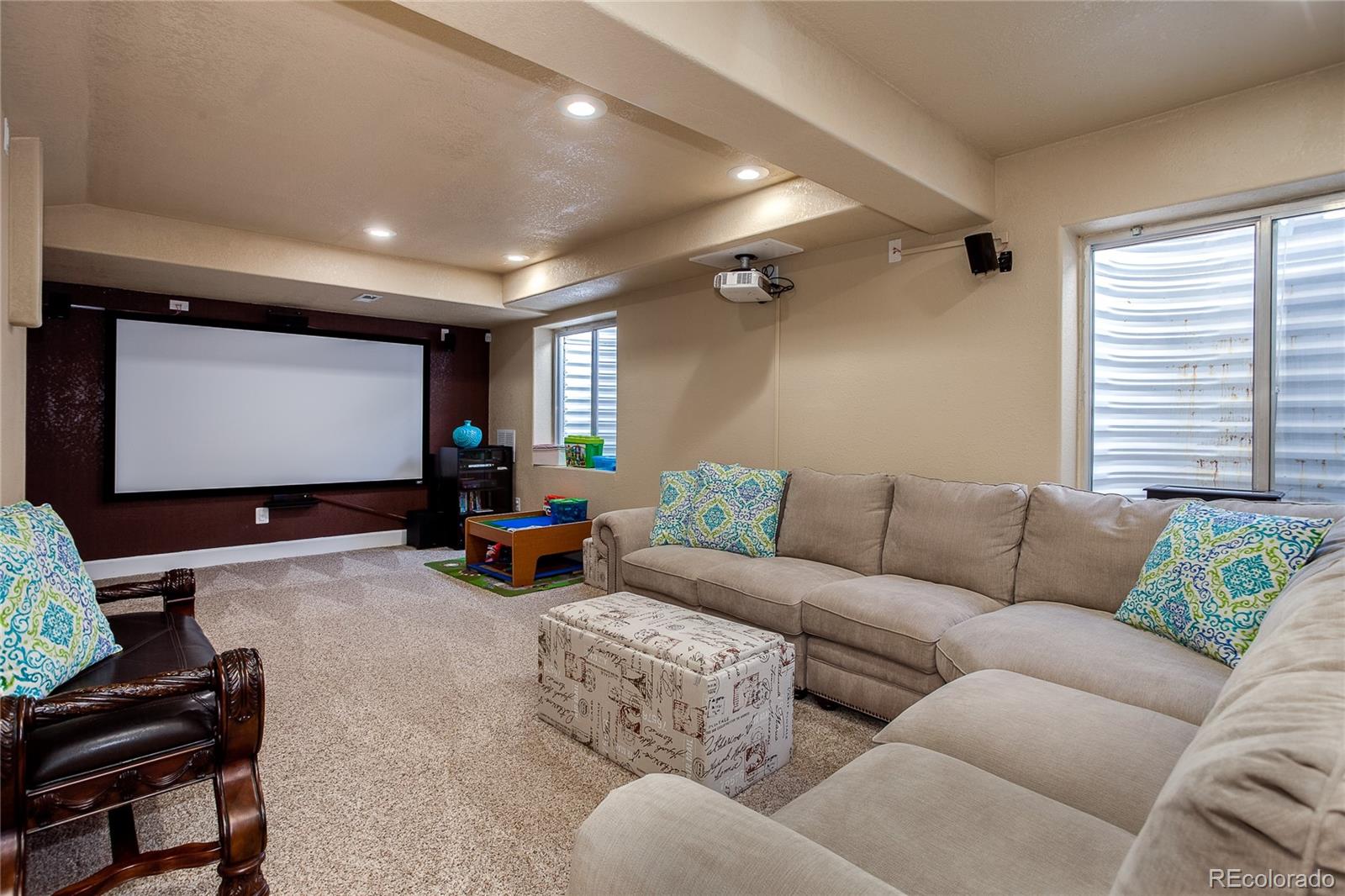 10839 Brooklawn Road Highlands Ranch, CO 80130 - Photo 15 of 32 a living room with furniture and a flat screen tv
