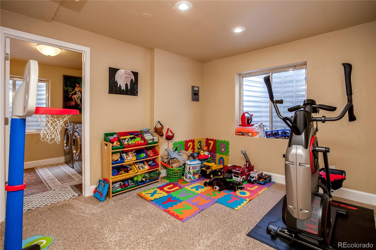 10839 Brooklawn Road Highlands Ranch, CO 80130 - Photo 17 of 32 a room with gym equipment and a table