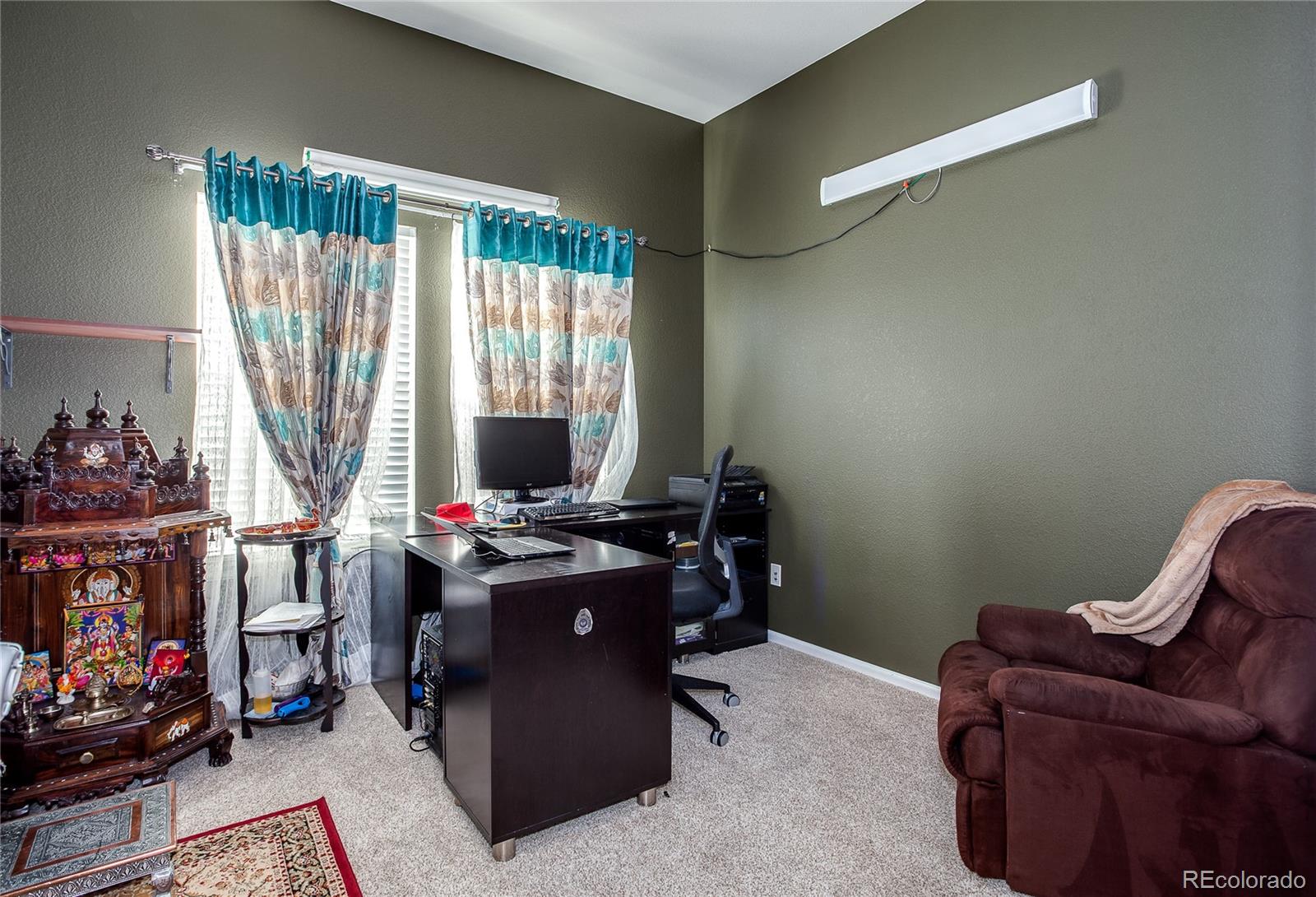 10839 Brooklawn Road Highlands Ranch, CO 80130 - Photo 26 of 32 a room with furniture and a fireplace