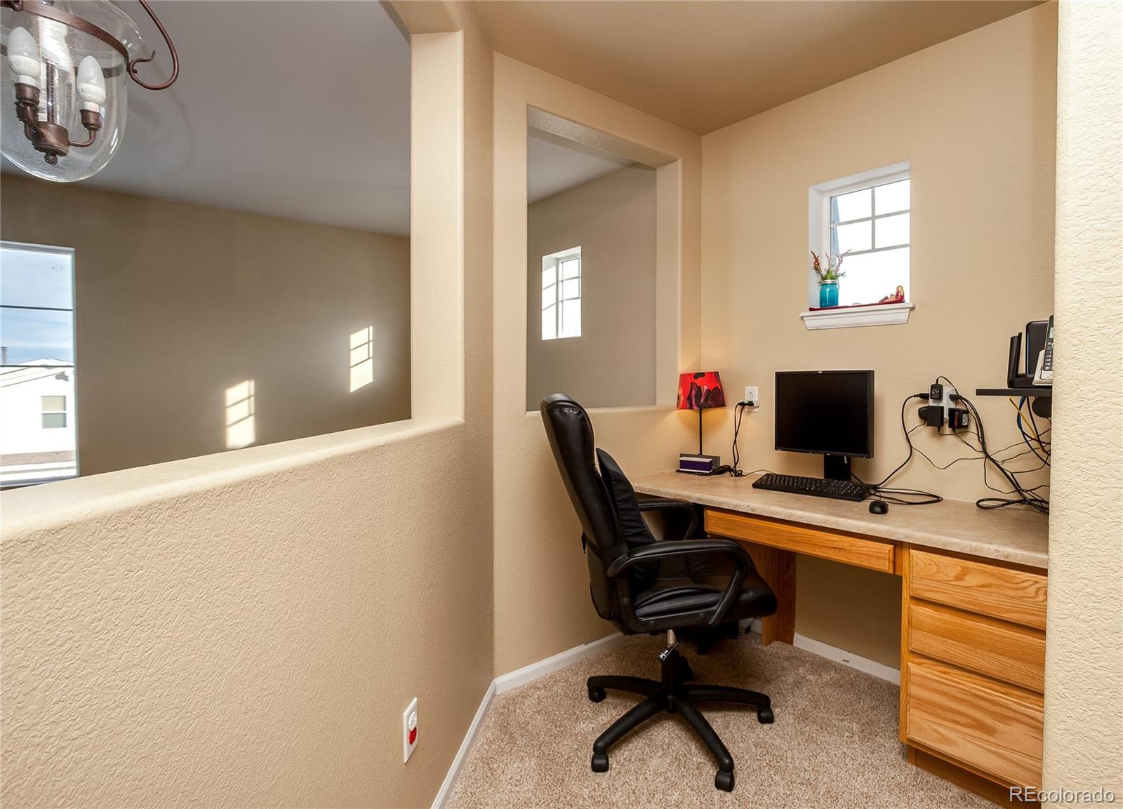 10839 Brooklawn Road Highlands Ranch, CO 80130 - Photo 29 of 32 a view of a workspace with furniture and a window