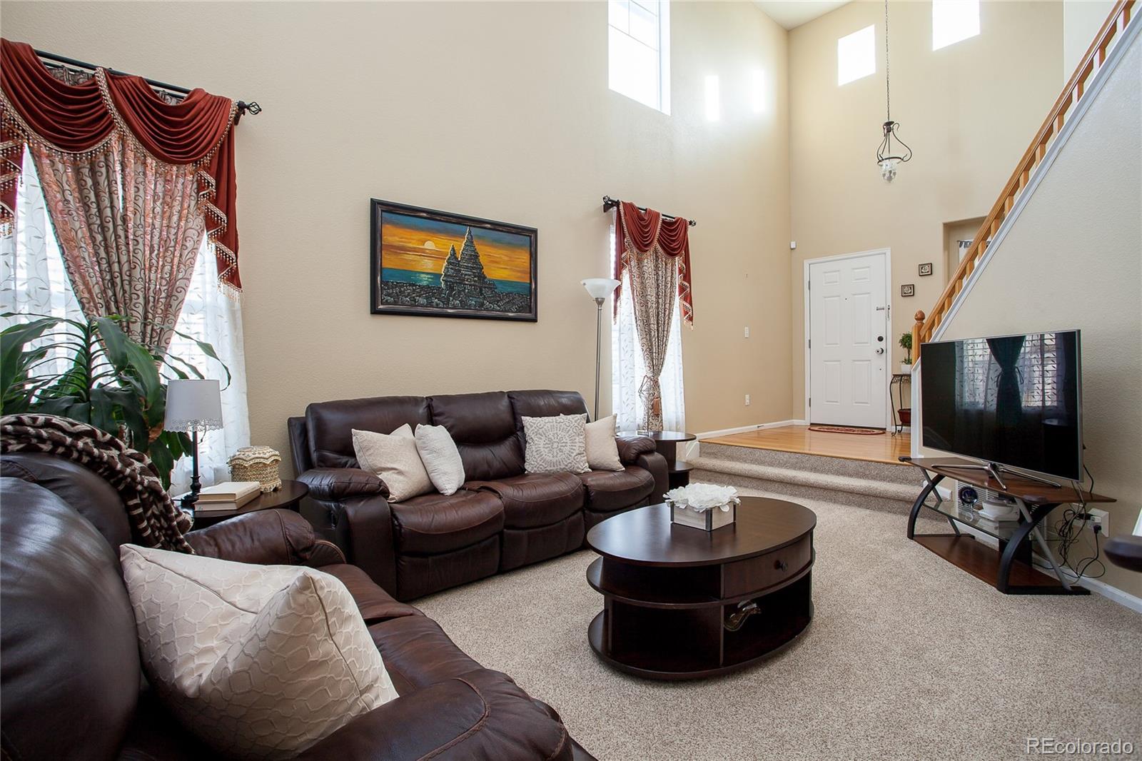 10839 Brooklawn Road Highlands Ranch, CO 80130 - Photo 6 of 32 a living room with furniture and a flat screen tv