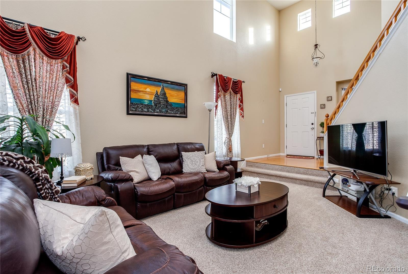 10839 Brooklawn Road Highlands Ranch, CO 80130 - Photo 7 of 32 a living room with furniture and a flat screen tv