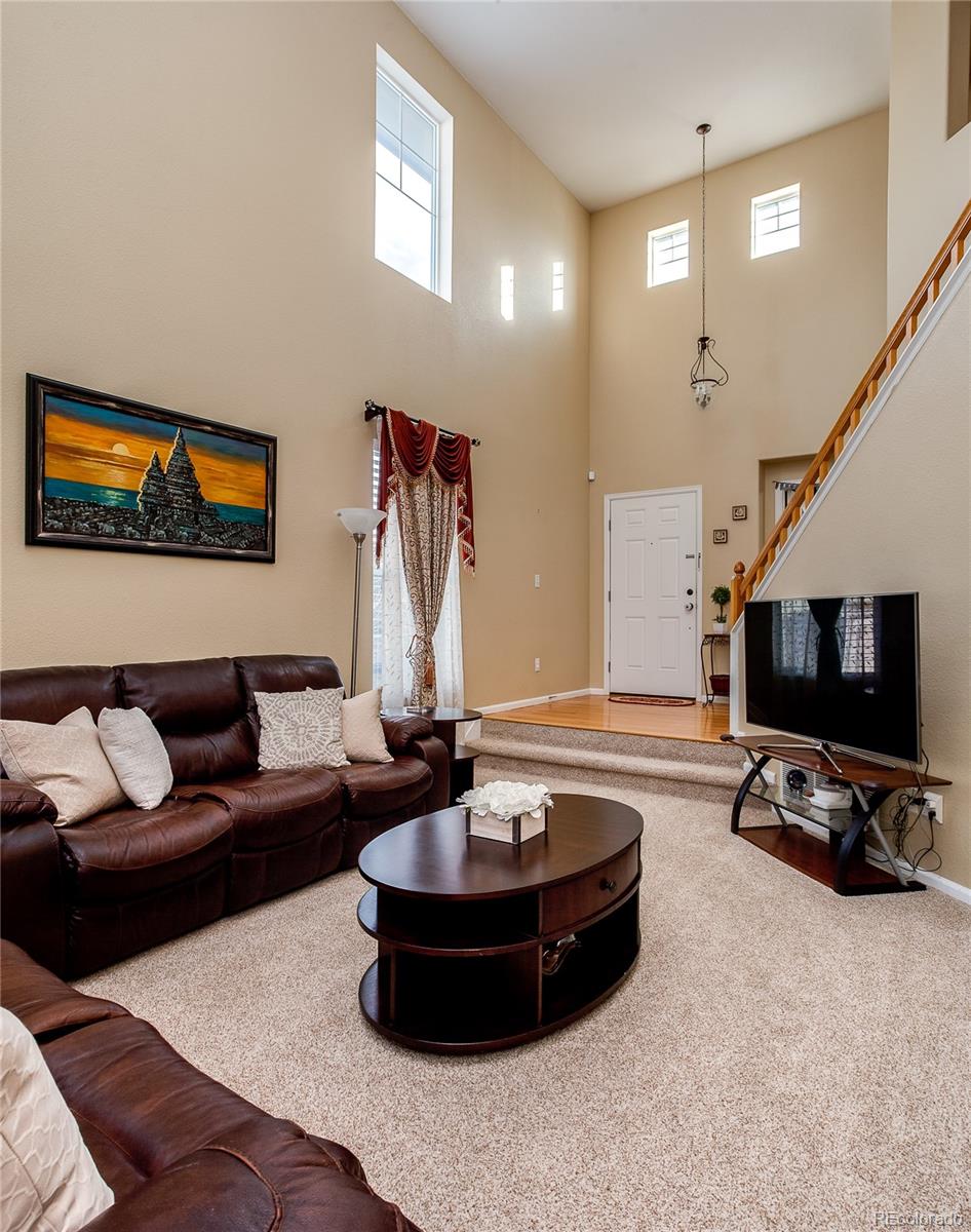 10839 Brooklawn Road Highlands Ranch, CO 80130 - Photo 8 of 32 a living room with furniture and a flat screen tv