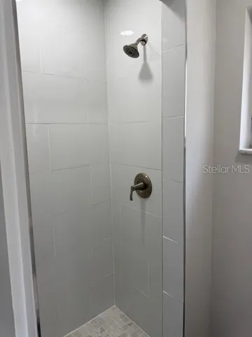 a white toilet sitting next to a white sink and vanity