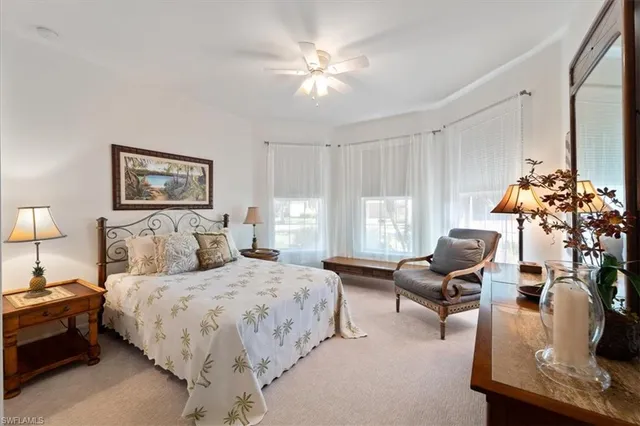 a bedroom with bed and a chandelier