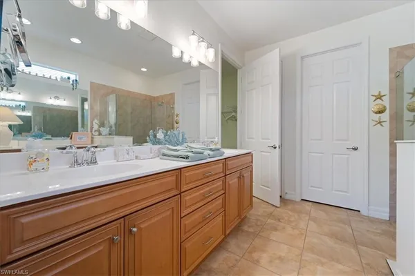 a bathroom with a double vanity sink a mirror and a