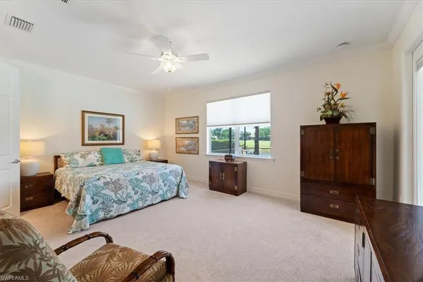 a spacious bedroom with a bed and a dresser