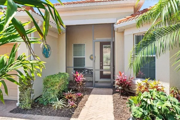 a front view of a house with a flower garden