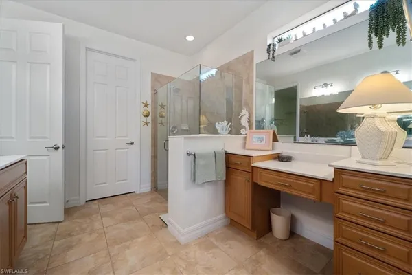 a large bathroom with a double vanity sink a mirror and a bathtub