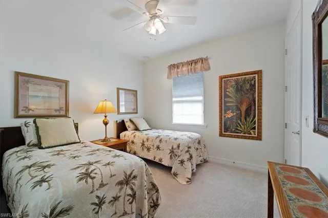 a bedroom with two beds and a window