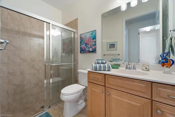 a bathroom with a toilet sink and shower