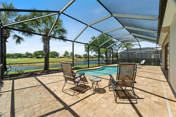 a view of a patio with a table and chairs