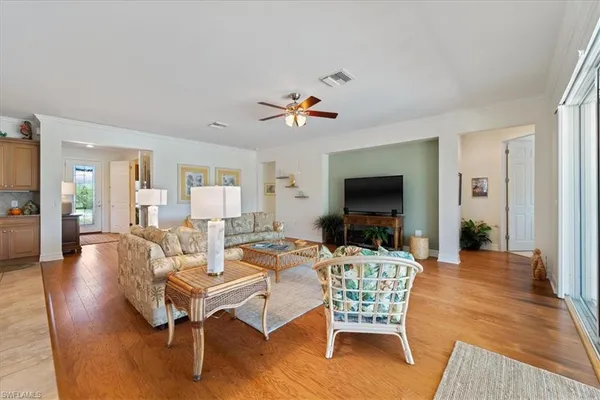 a living room with furniture a flat screen tv and a rug