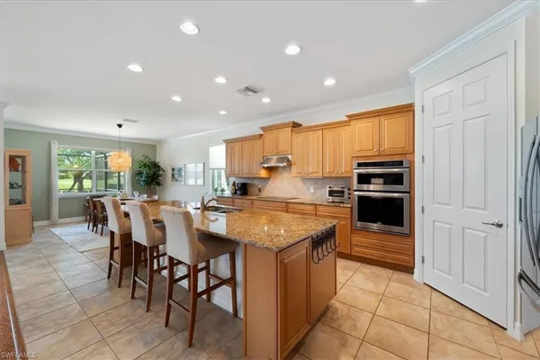 a kitchen with stainless steel appliances granite countertop a stove and a refrigerator