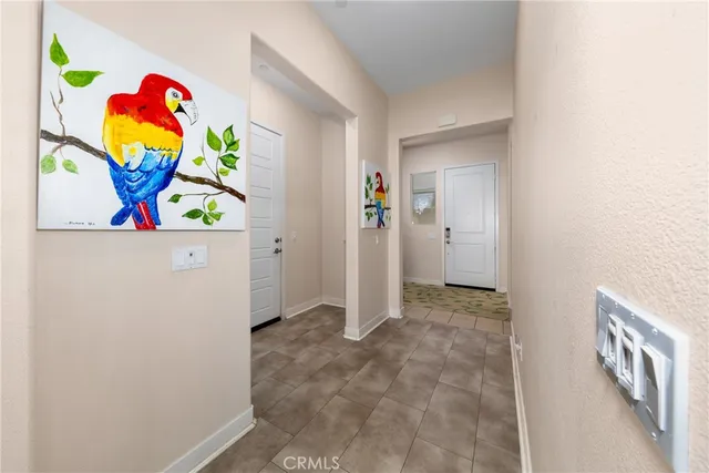 a living room with patio furniture and a flat screen tv