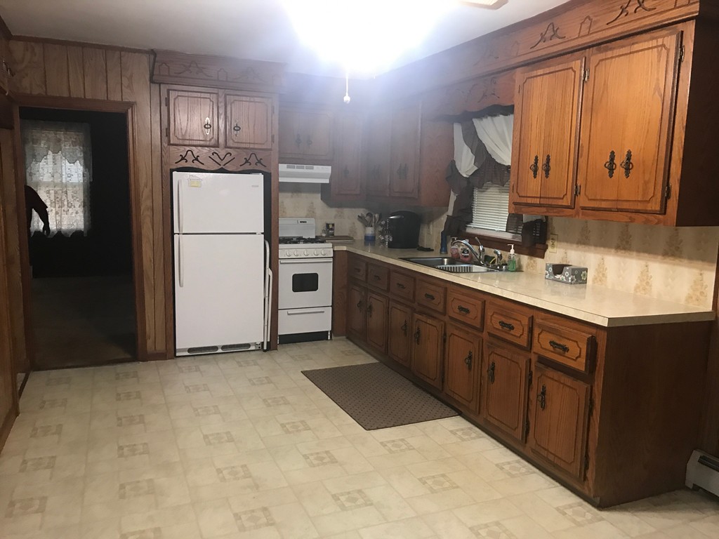 70 Hambly Street Fall River, MA 02721 - Photo 11 of 21 a kitchen with sink a refrigerator and cabinets