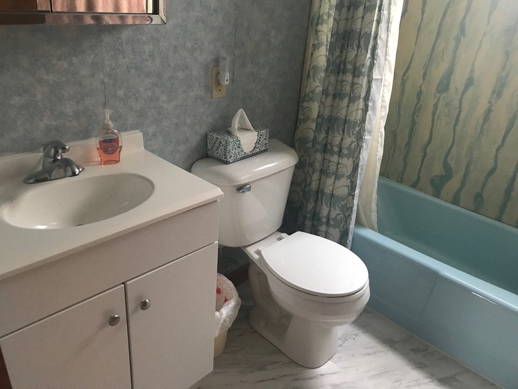 70 Hambly Street Fall River, MA 02721 - Photo 16 of 21 a white toilet sitting next to a bathroom sink