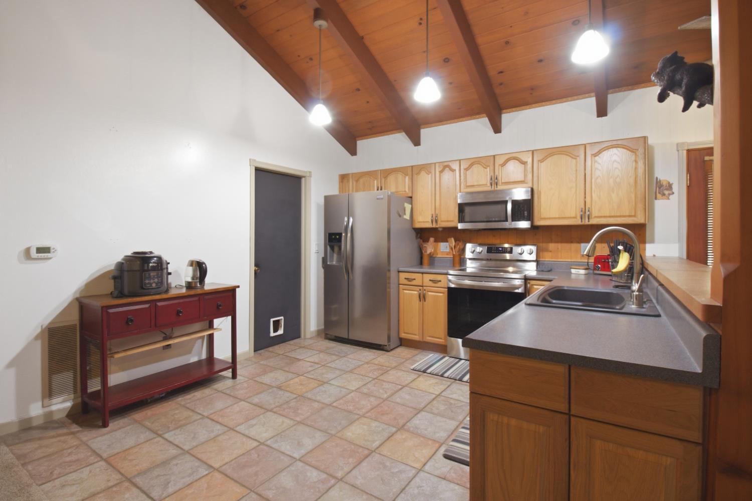 4599 Rivendale Road Placerville, CA 95667 - Photo 7 of 27 a kitchen with stainless steel appliances granite countertop a refrigerator and a stove