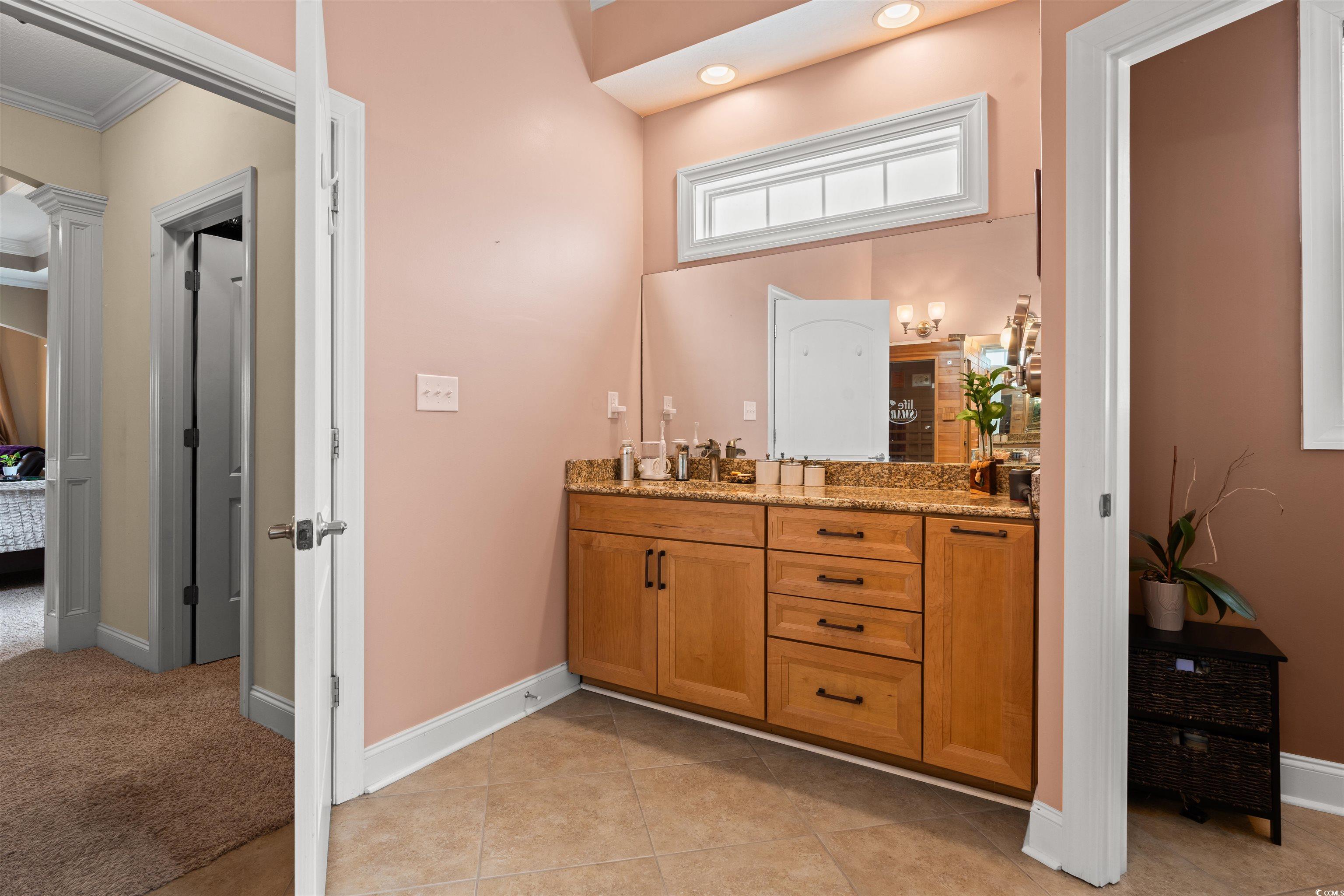 109 Eden Court Murrells Inlet, SC 29576 - Photo 12 of 31 Full bath with double vanity, light tile patterned floors, and ornamental molding