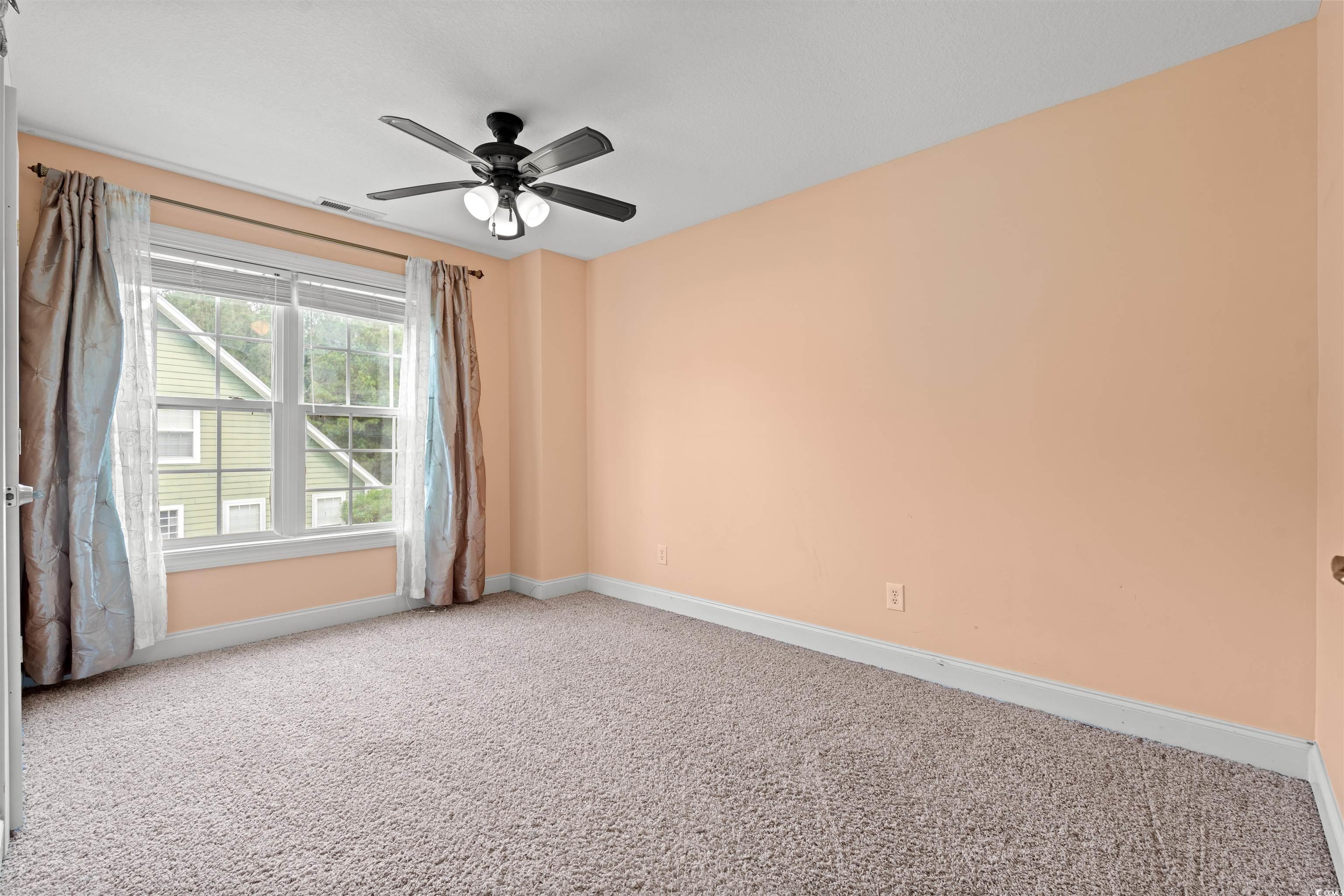 109 Eden Court Murrells Inlet, SC 29576 - Photo 15 of 31 Empty room featuring carpet floors and a ceiling fan