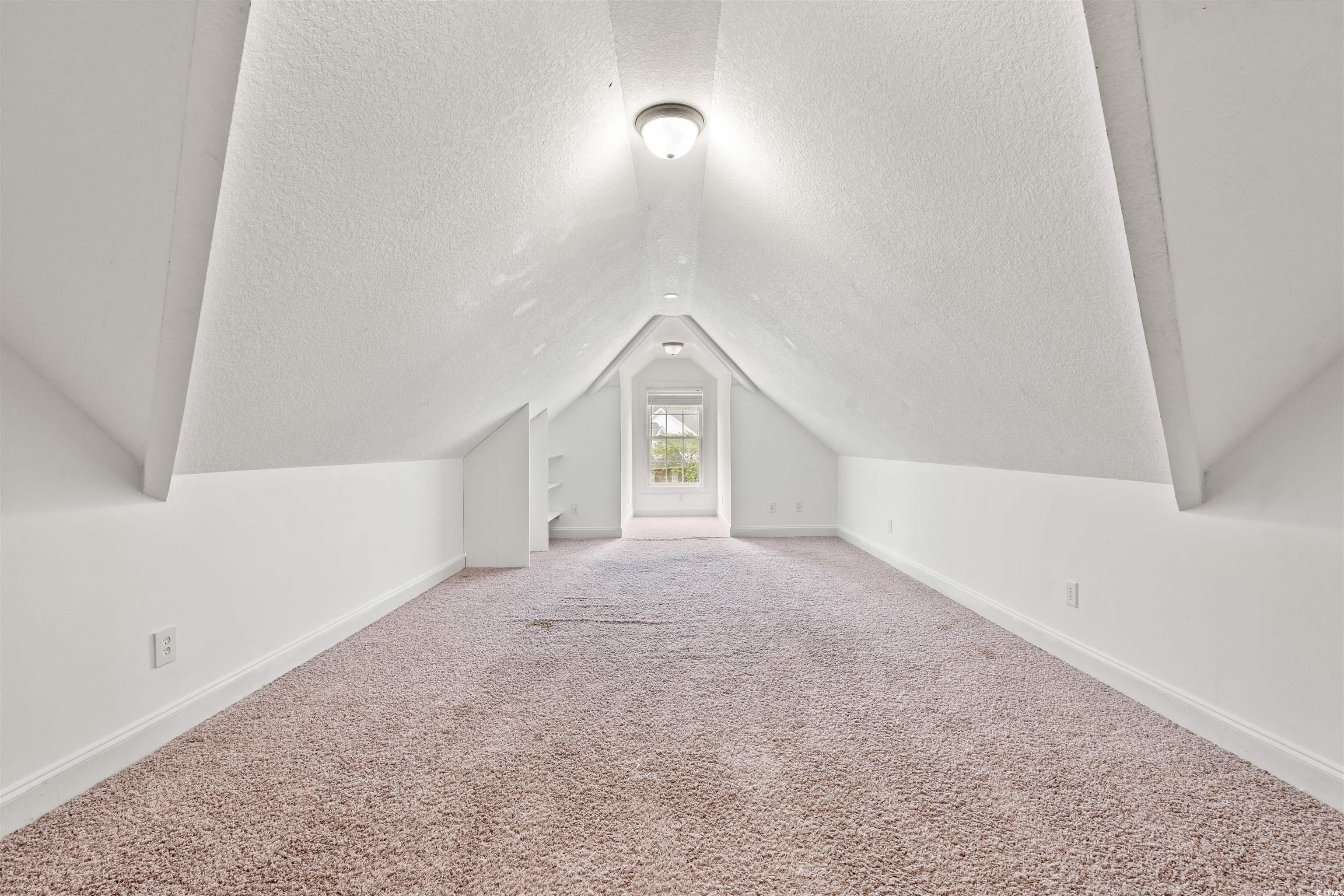 109 Eden Court Murrells Inlet, SC 29576 - Photo 17 of 31 Additional living space featuring carpet, a textured ceiling, and vaulted ceiling
