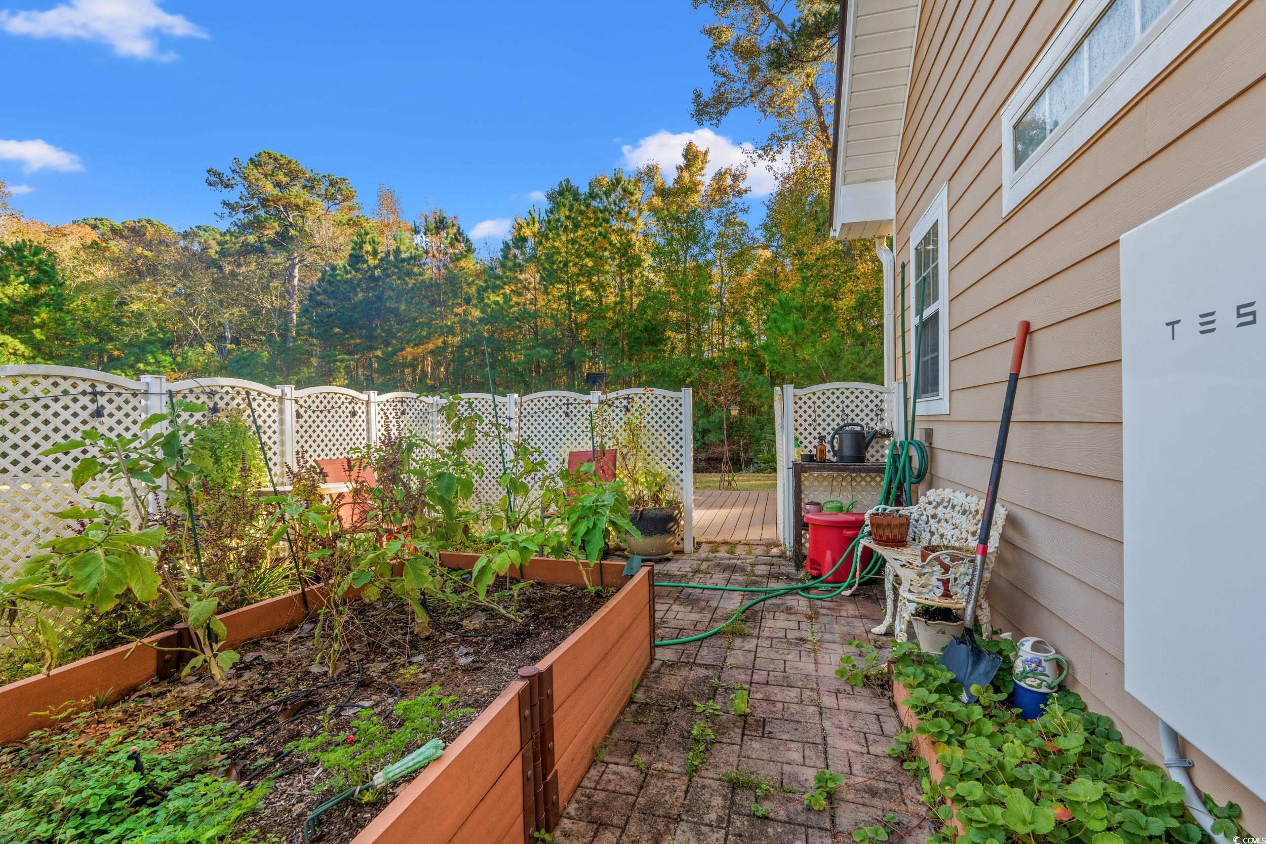 109 Eden Court Murrells Inlet, SC 29576 - Photo 29 of 31 View of yard with a garden and a wooden deck
