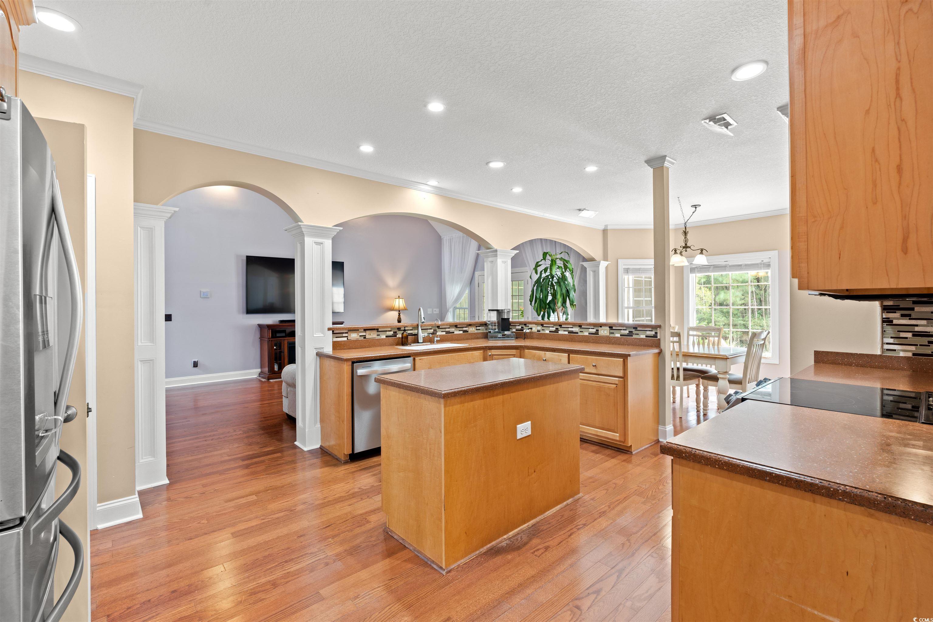 109 Eden Court Murrells Inlet, SC 29576 - Photo 7 of 31 Kitchen featuring decorative columns, appliances with stainless steel finishes, recessed lighting, light wood-type flooring, and ornamental molding