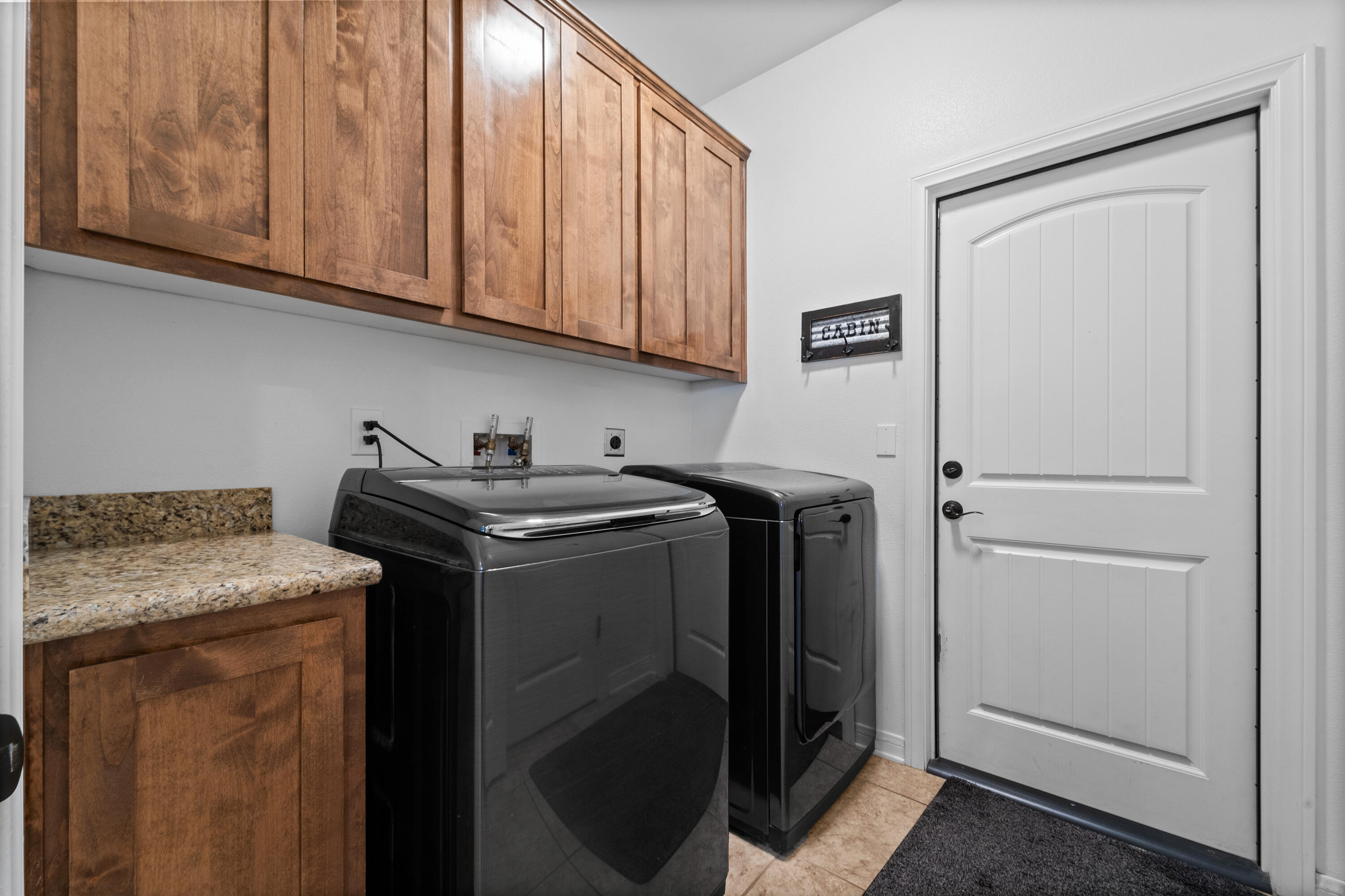 1231 Carolyn Street Ridgecrest, CA 93555 - Photo 19 of 49 a utility room with granite countertop cabinets washer and dryer