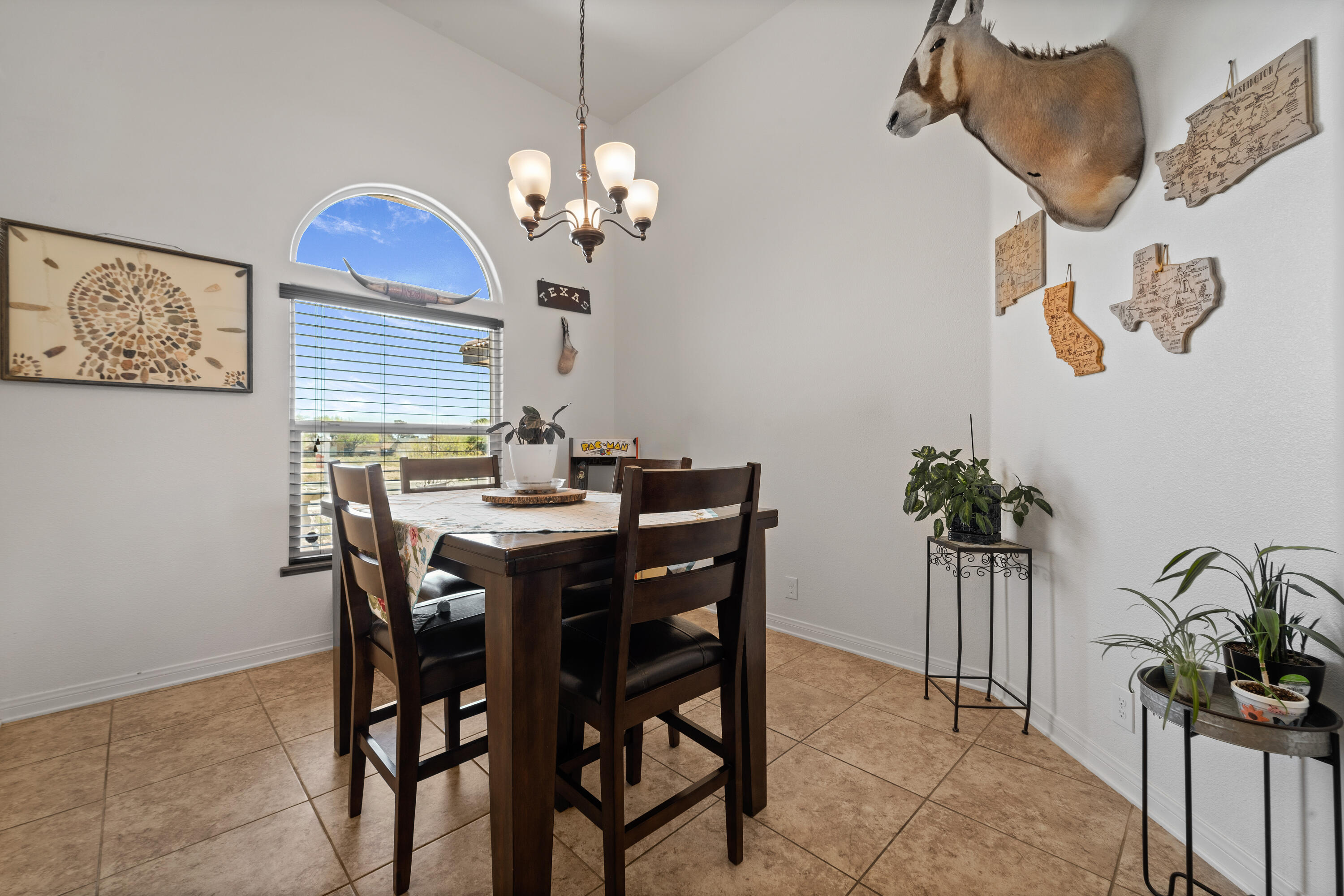 1231 Carolyn Street Ridgecrest, CA 93555 - Photo 21 of 49 a view of a dining room with furniture and a chandelier
