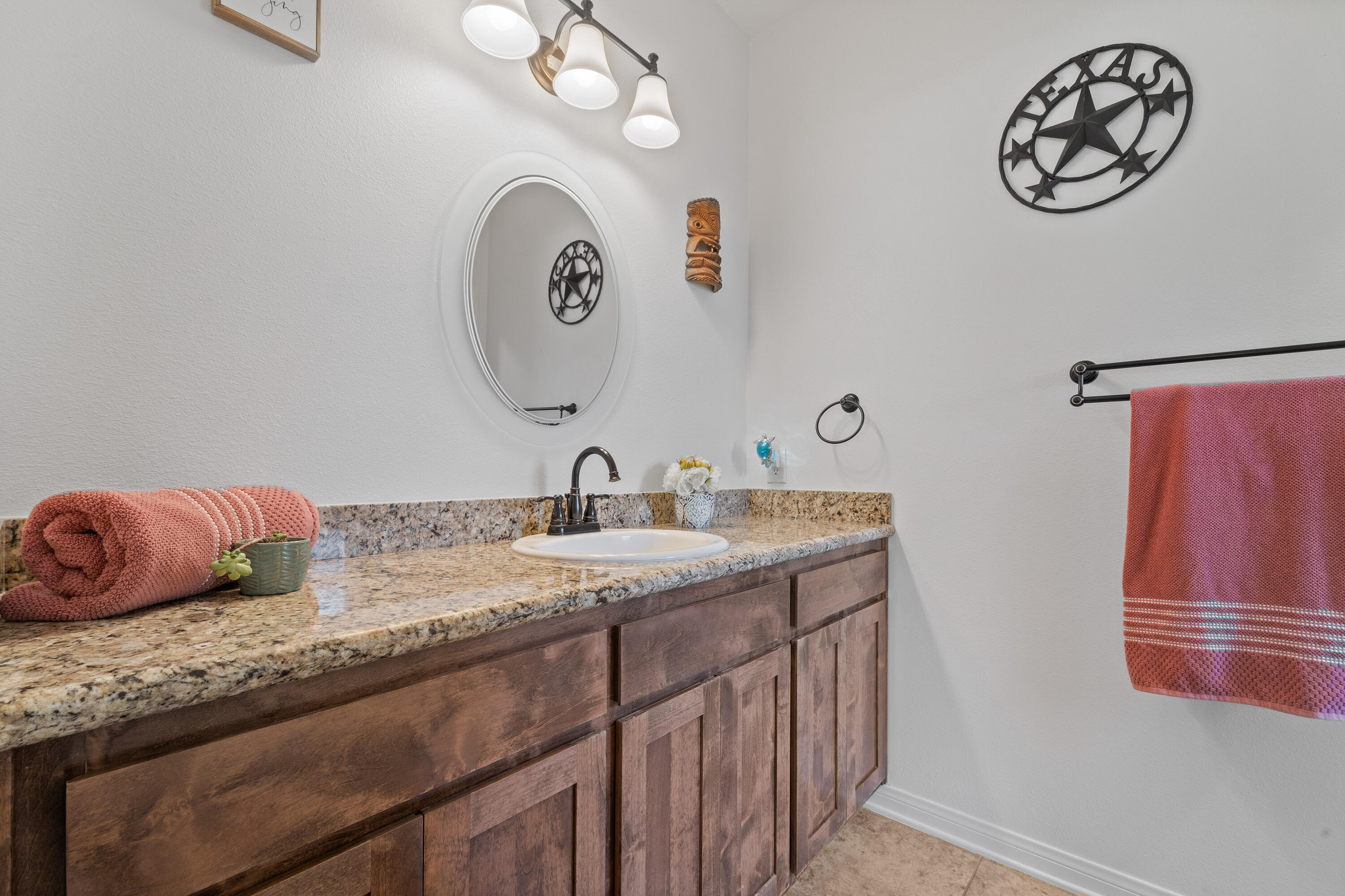 1231 Carolyn Street Ridgecrest, CA 93555 - Photo 24 of 49 a bathroom with a granite countertop sink and a mirror