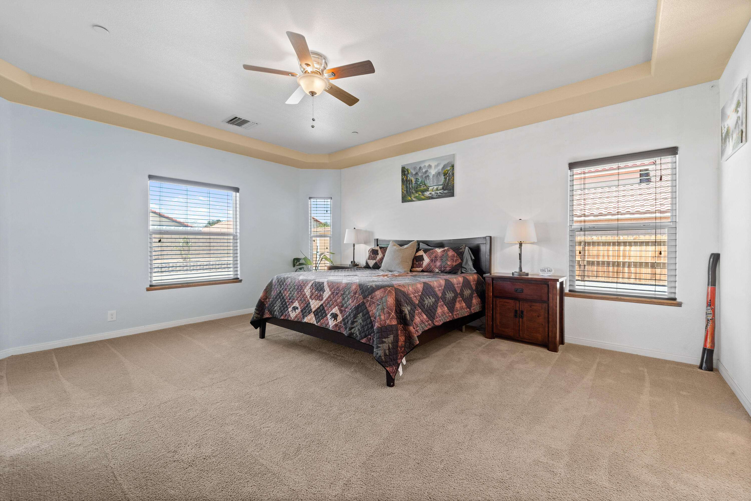 1231 Carolyn Street Ridgecrest, CA 93555 - Photo 30 of 49 a spacious bedroom with a bed painting and a window