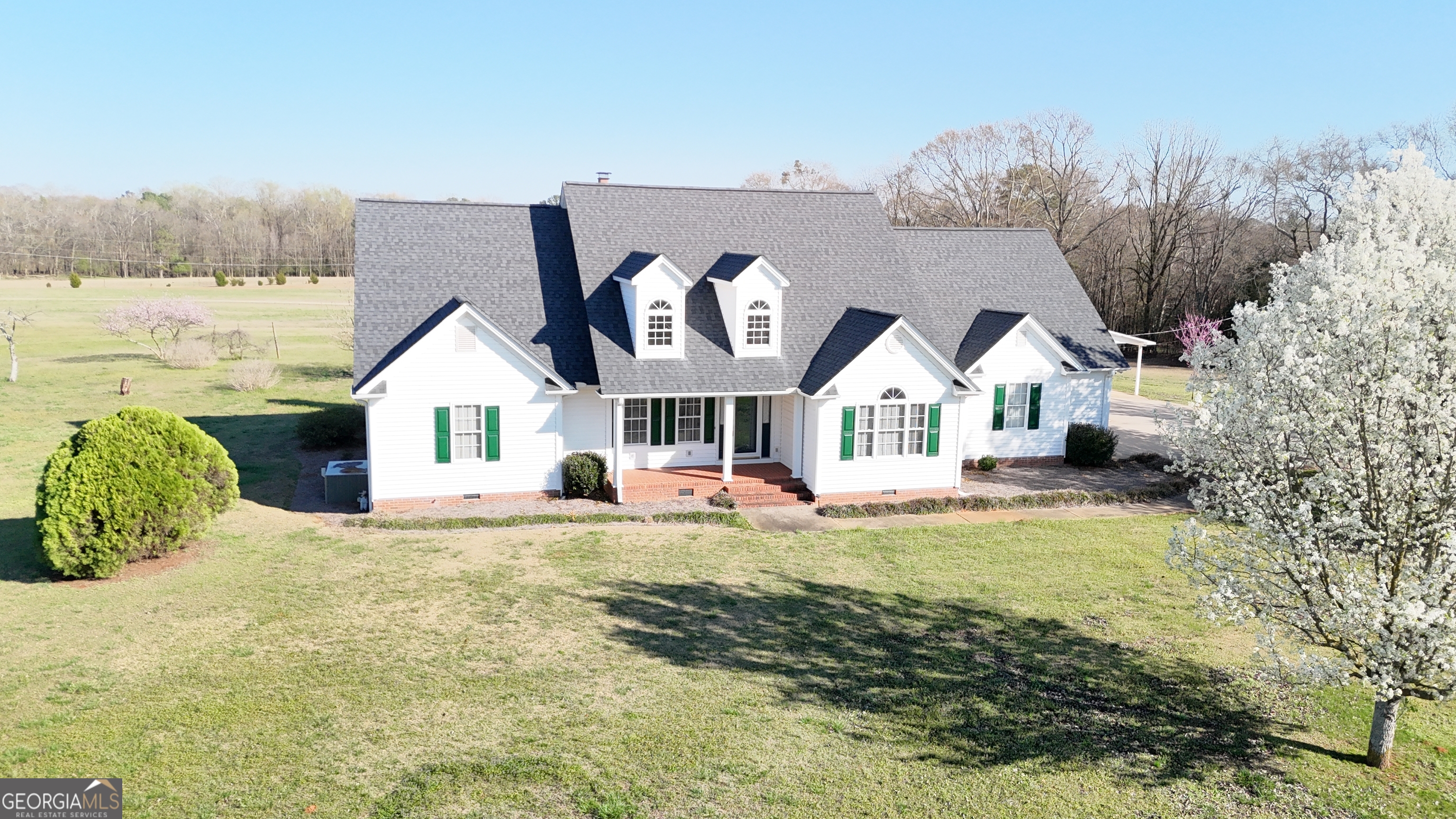 494 Broad Street Bowman, GA 30624 - Photo 2 of 65 a view of house with garden and tall trees