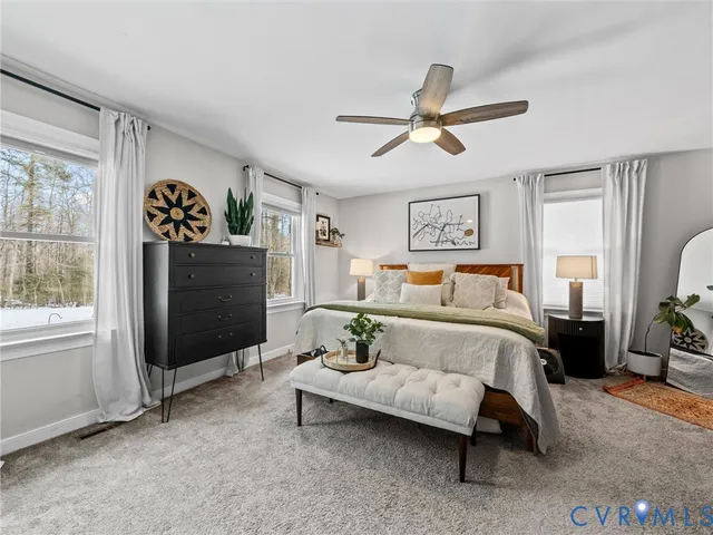 a bedroom with a bed couch and window