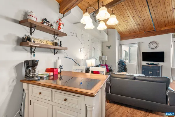 a kitchen with kitchen island white cabinets and appliances