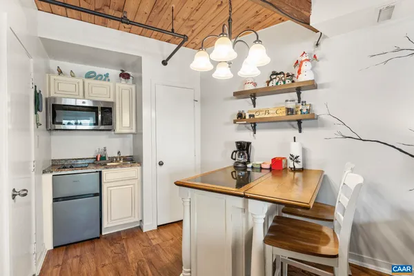 a kitchen with stainless steel appliances white cabinets and a stove top oven